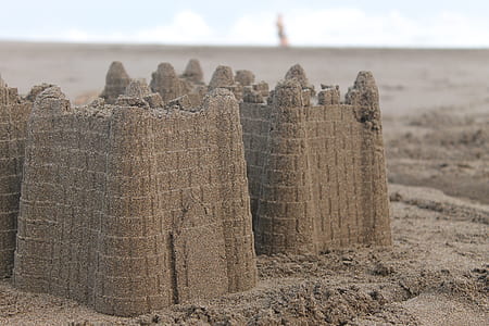 sand castle on beach at daytime close-up photography thumbnail