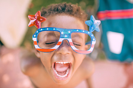 Kid Celebrating 4th of July with red white blue glasses thumbnail