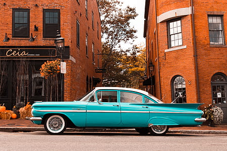 vintage teal sedan under sunny sky thumbnail