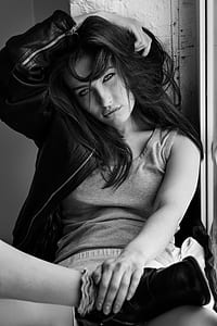grayscale photography of woman in tank top and full-zip jacket thumbnail
