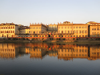 concrete buildings during sun set near body of water thumbnail