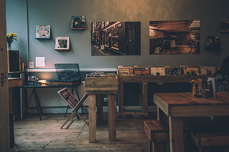 brown wooden table filled with vinyl records thumbnail