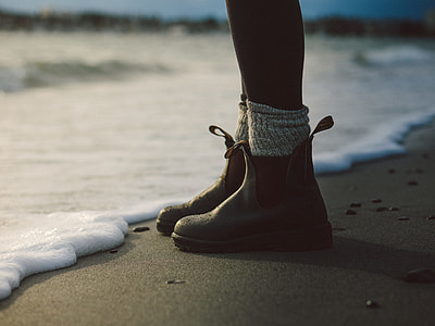 photo of person standing on gray sand thumbnail