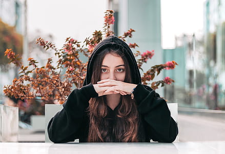 woman sitting on chair with hand on her lips thumbnail