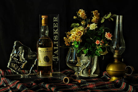 liquor bottle near flowers on vase thumbnail