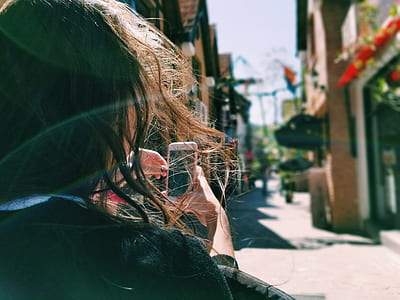 woman holding pink smartphone thumbnail