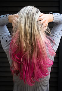 Woman in Gray Long-sleeved Top Holding Hair thumbnail