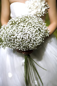 photo of woman wearing white wedding dress holding white petaled flowers bouquet thumbnail