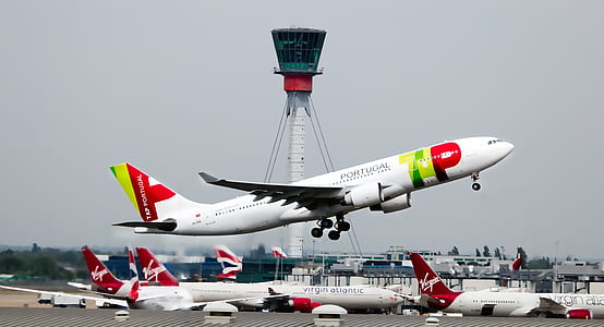 white and red airplanes during daytime thumbnail
