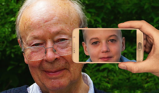 person holding turned on smartphone near man's face thumbnail