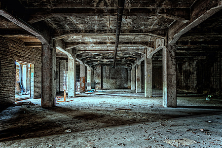 photo of concrete pillar building in room with brick walls thumbnail