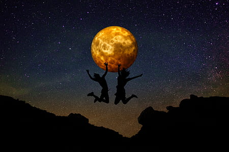 two silhouette persons jumping on cliff with moon background thumbnail