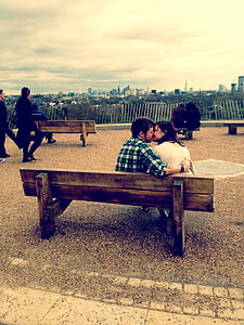 man and woman kissing on bench thumbnail