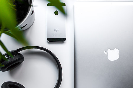 space gray iPhone 5s beside MacBook thumbnail
