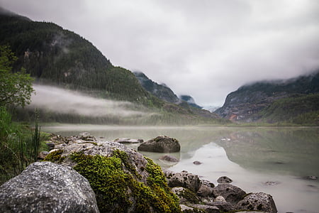 mountain near body of water under fog thumbnail