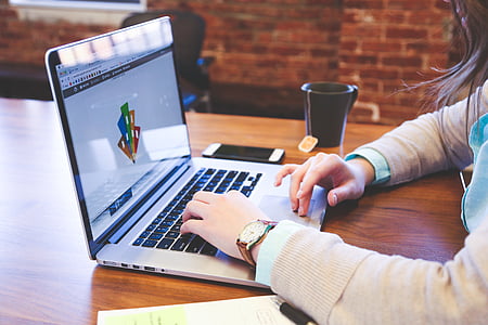woman using her laptop near black ceramic mug thumbnail