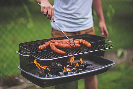 man grilling food during daytime thumbnail