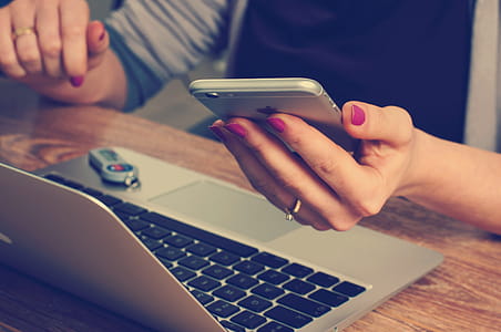 woman sitting in front of MacBook Air using gold iPhone thumbnail