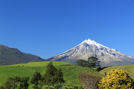 photography of mountain near on field thumbnail