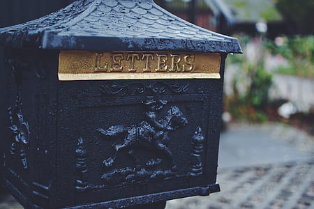 close-up photography of black and brass-colored letters box thumbnail