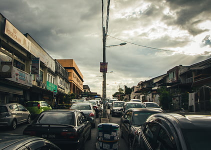cars on road under dramatic clouds during daytime thumbnail