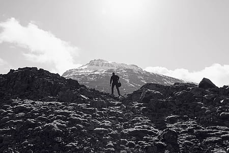 grayscale photo of man hiking thumbnail