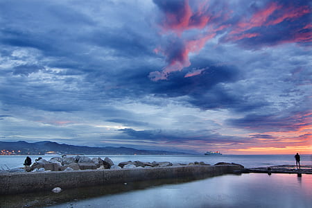 gray concrete dock under blue and pink cloudy sky thumbnail