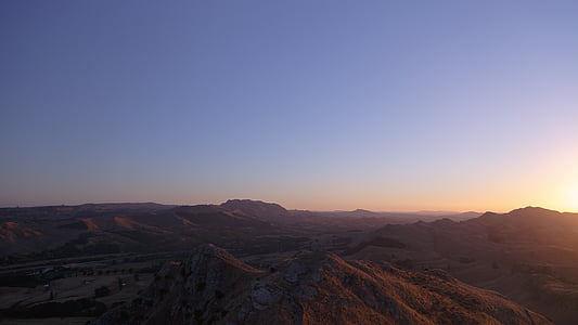 aerial photography of mountains under calm blue sky thumbnail