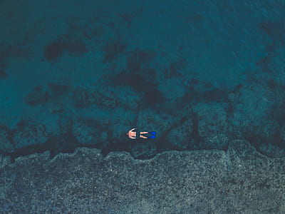 man snorkeling on clear body of water thumbnail