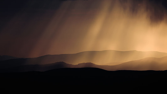 silhouette of mountain with sun rays thumbnail