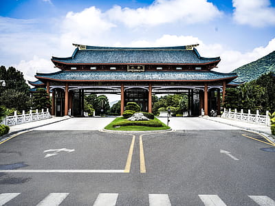 Blue and Brown Temple Near Gray Pavement Road thumbnail