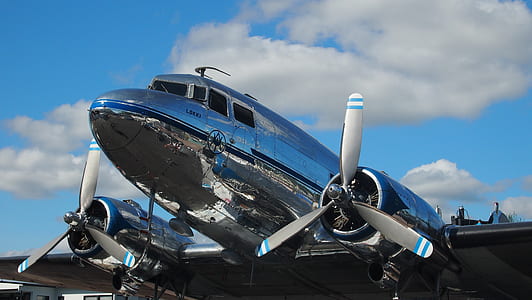 silver airliner under white clouds thumbnail