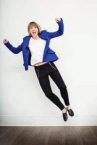 woman jump wearing blue peaked lapel suit jacket and black pants thumbnail
