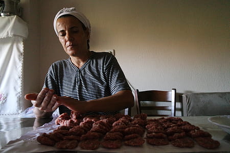 Woman Wearing Black and White Striped Top Preparing Food thumbnail