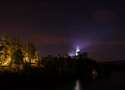 lighthouse during night thumbnail