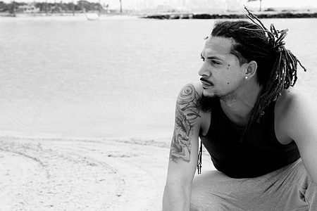 man wearing tank top in grayscale photography thumbnail