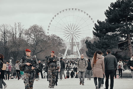 soldiers and people standing near ferris wheel thumbnail