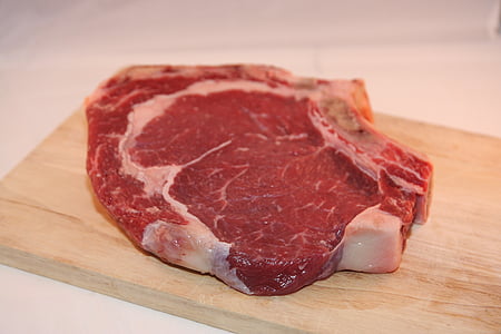 raw meat on brown wooden board thumbnail