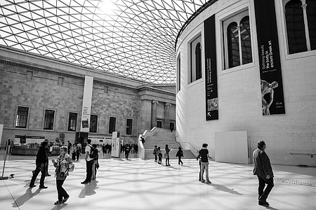 Black and white shot of people enjoying some time in the British Museum in London. This image was captured in the Great Court, this courtyard area was created by Foster and Partners architects back in the year 2000. The result is a two-acre public space with a wonderful glass roof that is recognised as the largest covered public square in Europe thumbnail