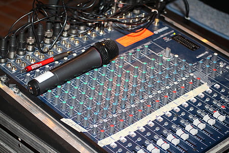 black handheld microphone on top of audio mixer thumbnail