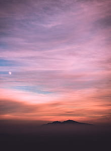 silhouette of mountains under cloudy sky thumbnail