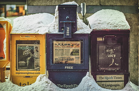 three assorted mail boxes covered by snow thumbnail