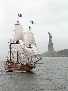 sail ship sailing near Statue of Liberty thumbnail