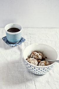 two white ceramic cups on bed mattress thumbnail