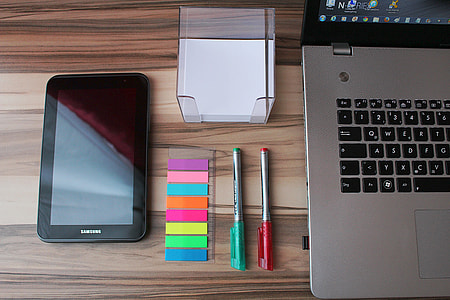 black Samsung Galaxy Tab with green and red pen near black and gray laptop computer thumbnail