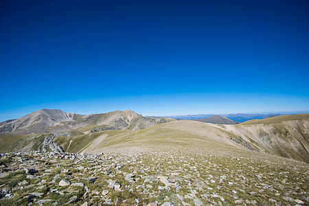 landscape photo of brown mountains under blue sky during daytime thumbnail