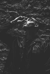grayscale photo of man wearing black button-up jacket thumbnail