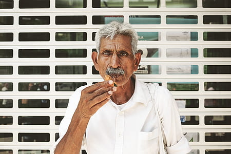man wearing white button-up collared shirt in front of white roller thumbnail