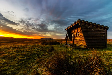 brown wooden house on green grass thumbnail