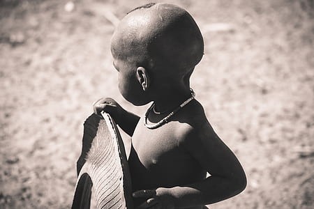 grayscale photography of boy looking away at the camera thumbnail